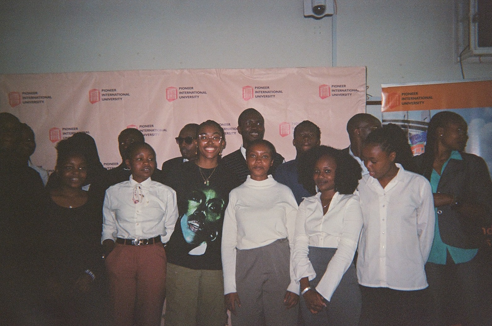 Isis and about a dozen Kenyan first year university students standing side to side for the photo.