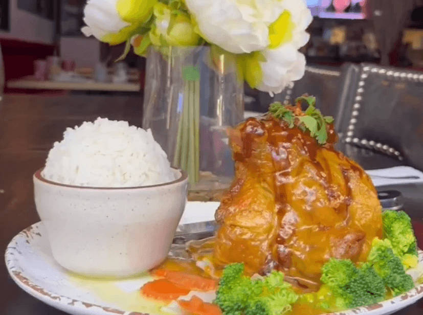 Chicken drizzled with sauce, broccoli, and a little bowl of rice