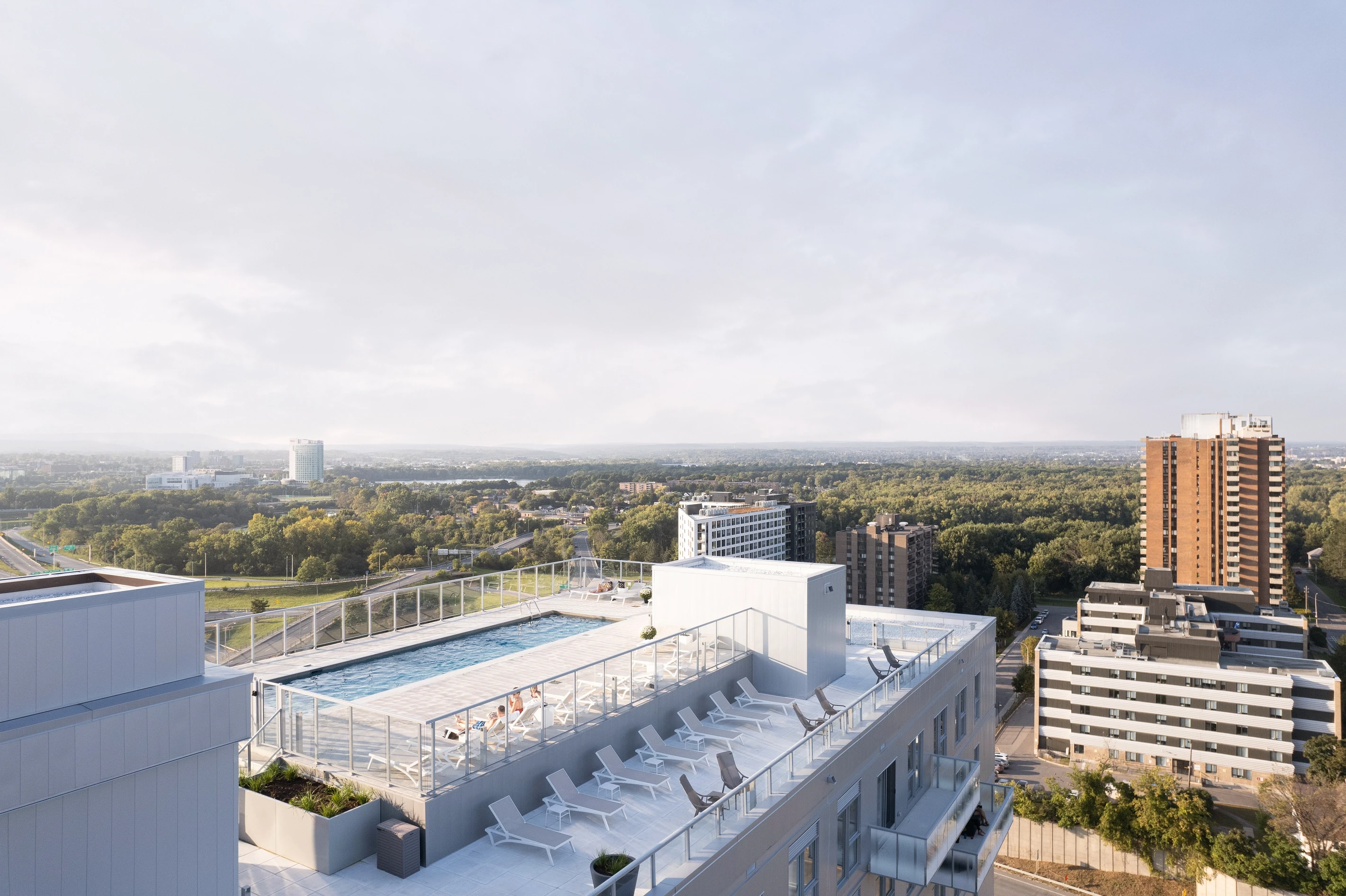 Aerial view of Éléonore’s rooftop swimming pool, modern leisure space with panoramic city views and architectural precision.