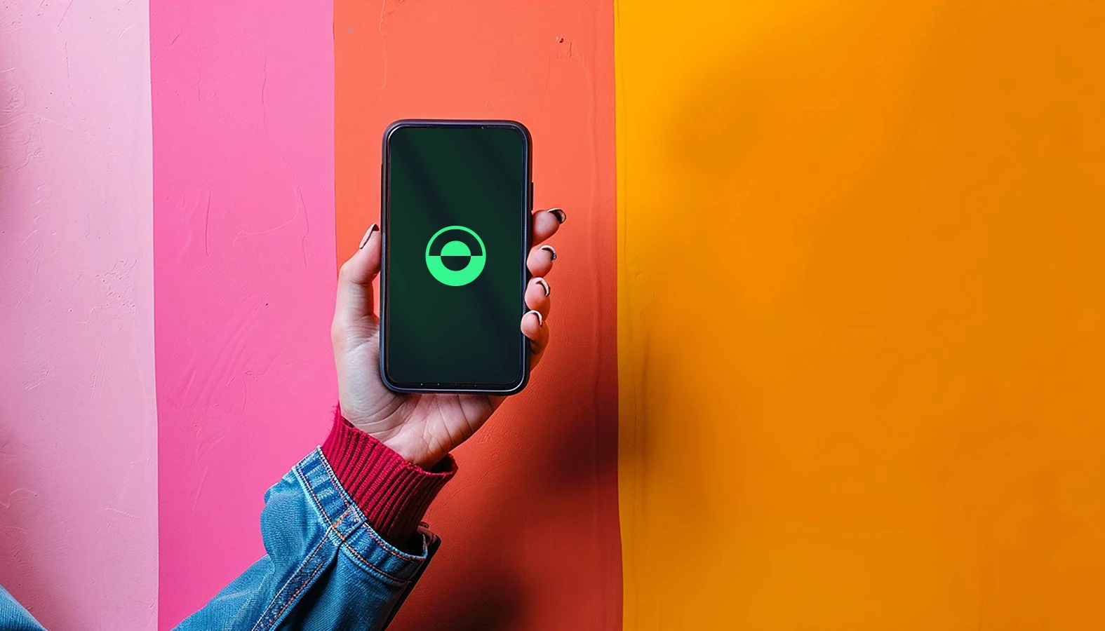 A female hand is holding a phone over a colourful background with the new UpWatch logo on the phone