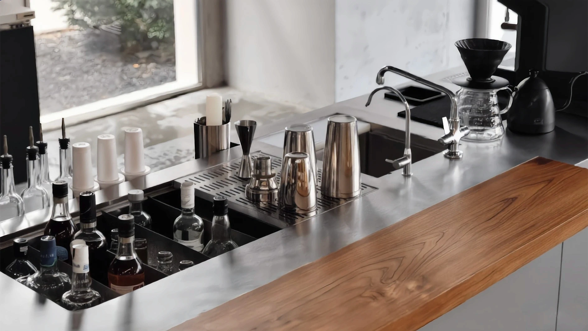 Custom stainless steel coffee station featuring a sleek integrated multi-station pour-over island, under-counter refrigeration, and professional water filtration systems for a commercial cafe.