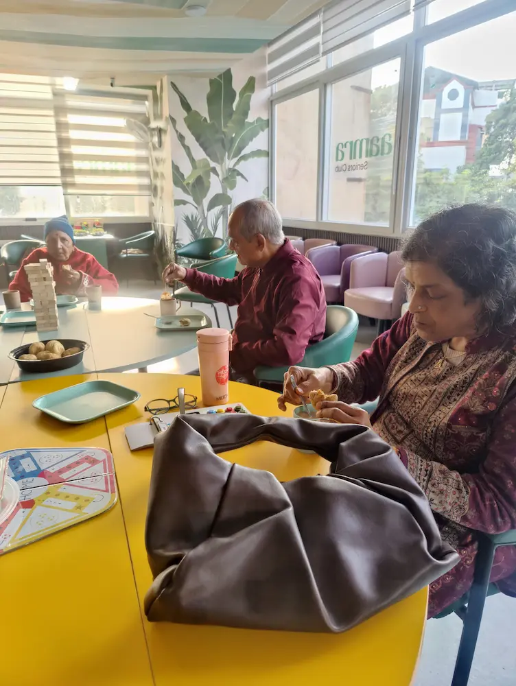 Members enjoying snacks at Aamra Seniors Club
