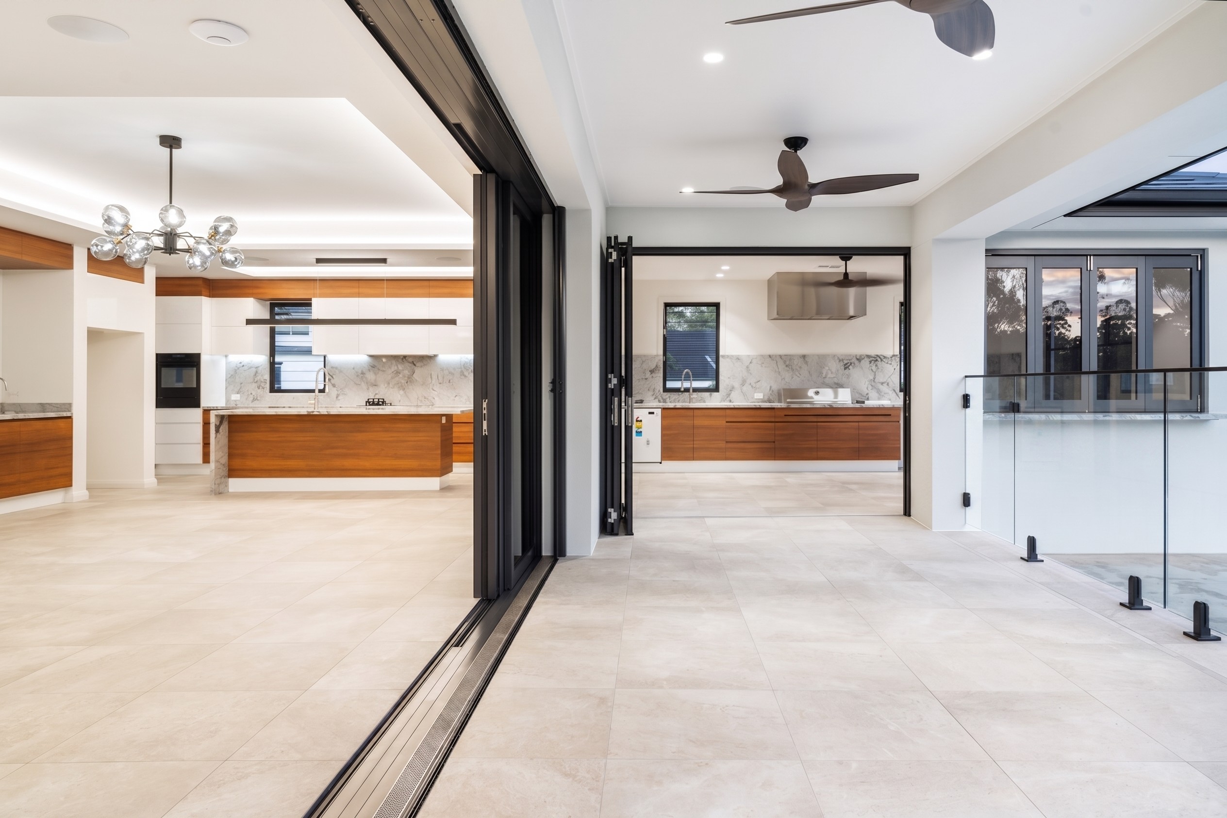 Modern open-plan kitchen and indoor-outdoor living space.