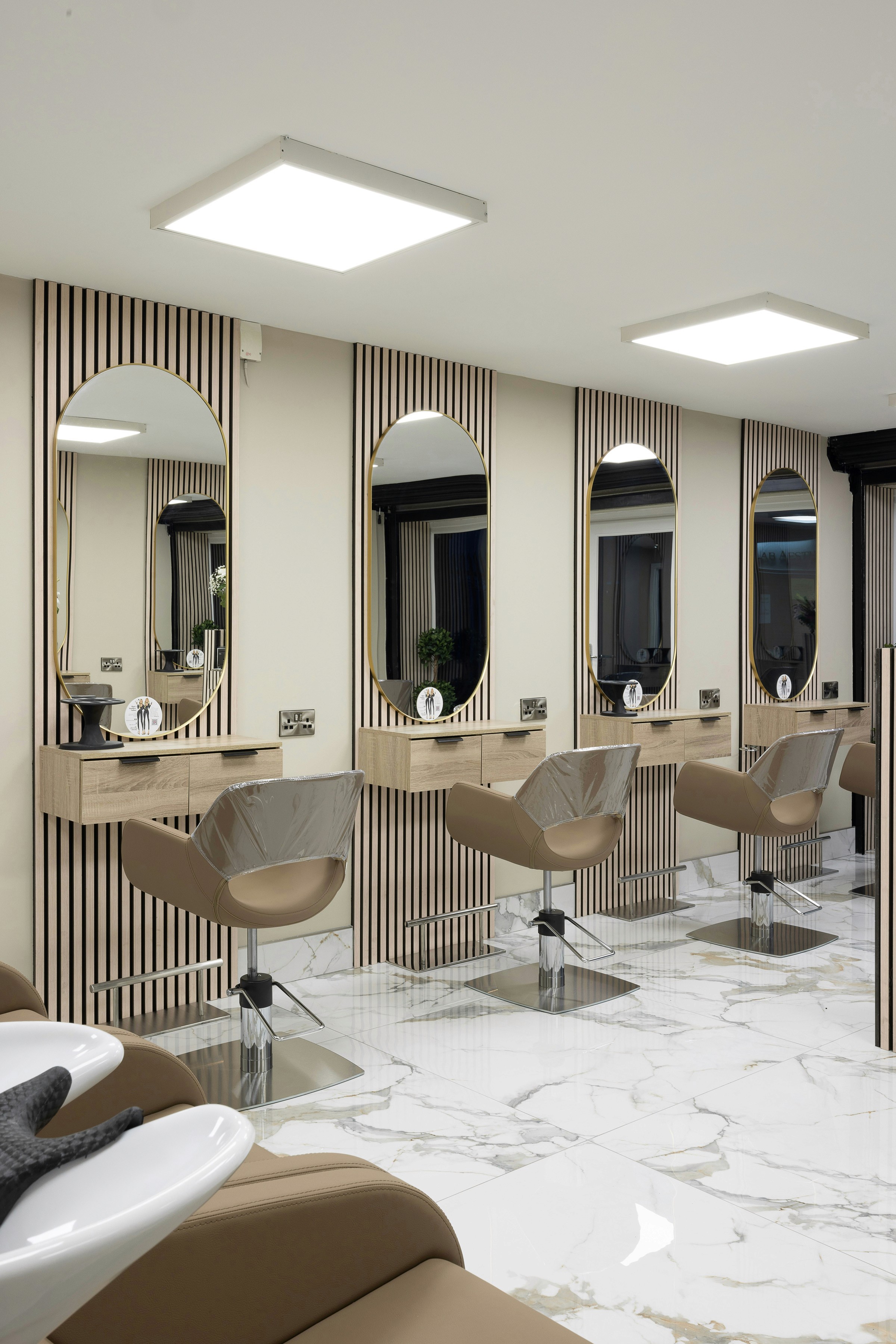 Modern salon with marble floors and styling stations