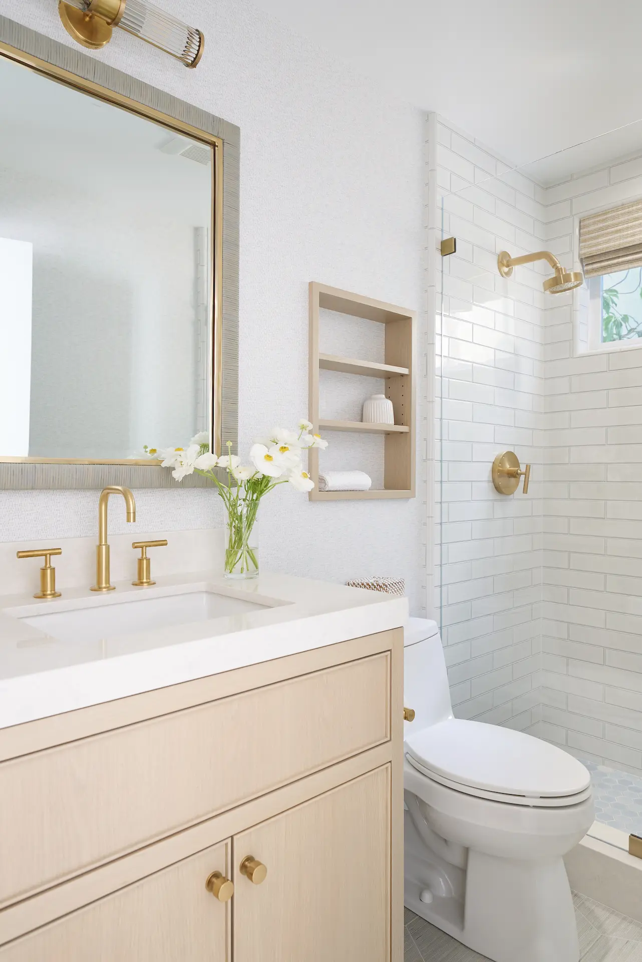 View of the vanity and shower area in the guest bathroom, highlighting fixtures and design in the Irvine Contemporary Coastal Remodel. Photo by Todd Huge.