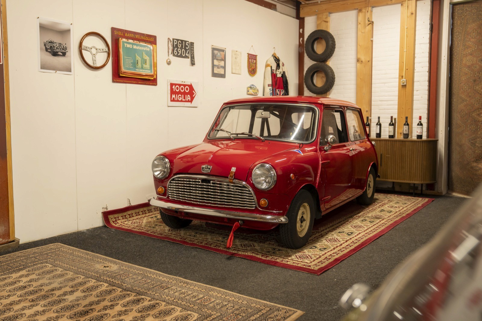 Detail of a pink vintage mini classic vehicle showing a black window with a stylized logo and the phrase "Commands".