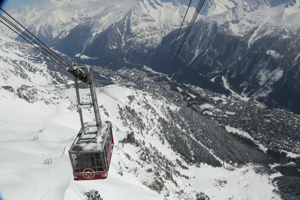 A man stading with Surfboard