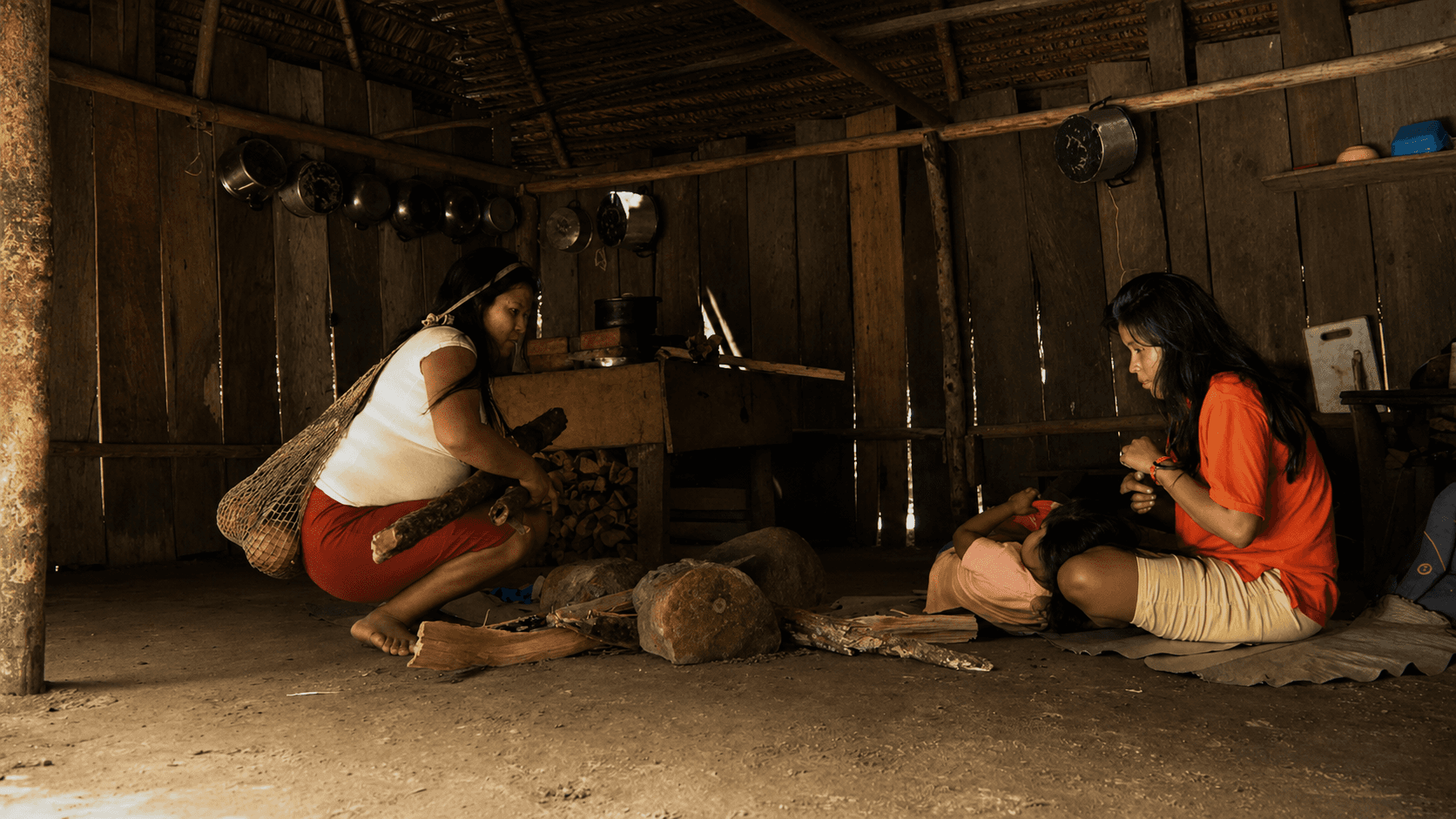 Young U’wa women leaving a traditional community house in the mountains of Arauca, Colombia.
