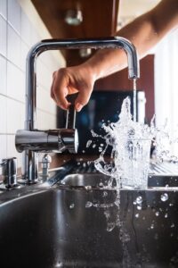 Water filling a glass from a faucet