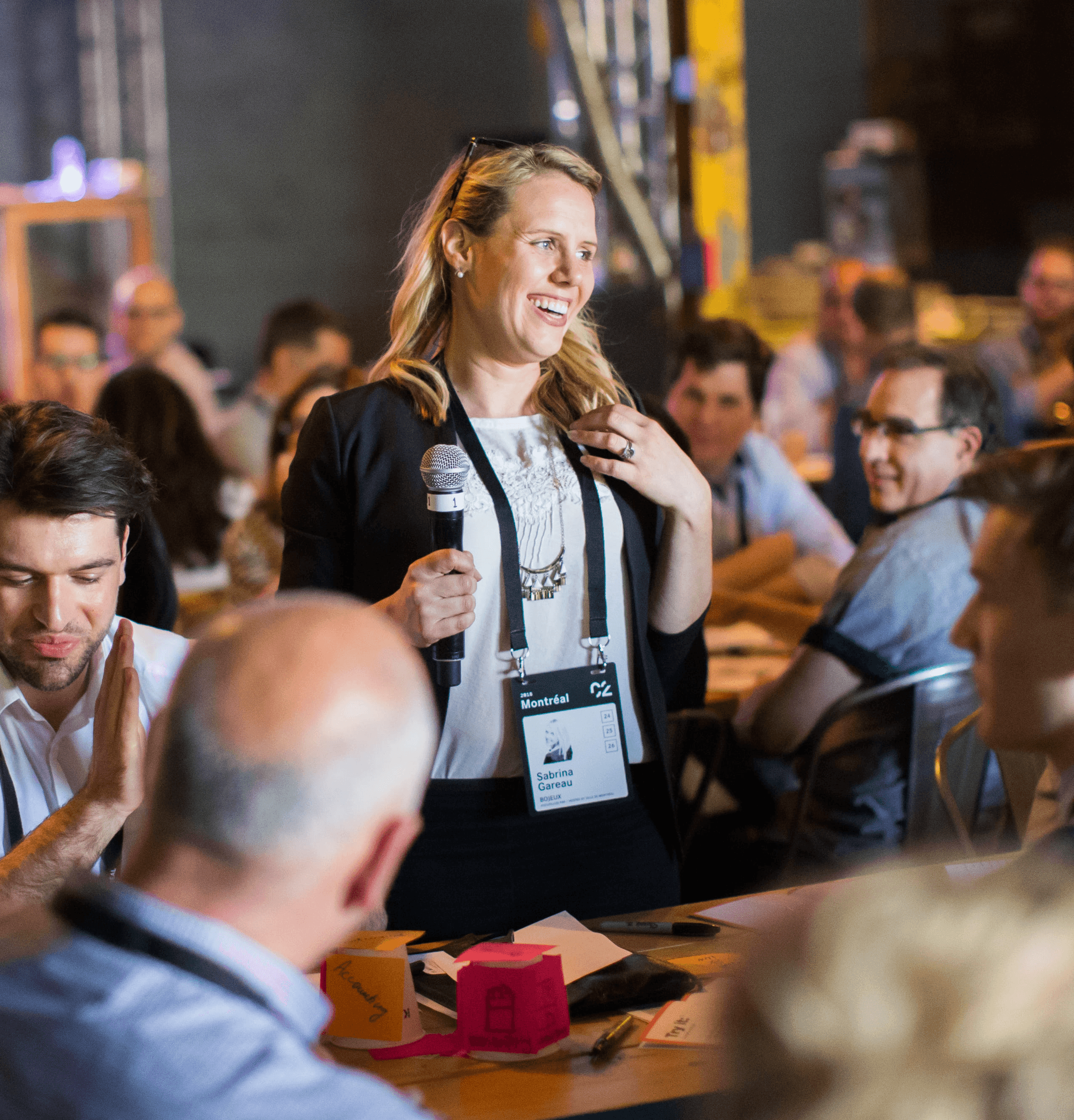 Speaker engaging with participants during a collaborative workshop at a C2 event, fostering dialogue and creative exchange.