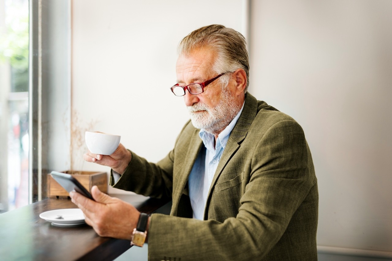 A SME Owner standing in his production facility smiling