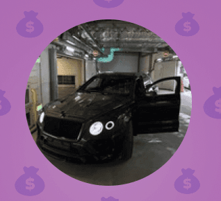 Fashion portrait of a woman in a wide-brim hat and graphic pink patterned shirt standing in front of a bright pink wall under clear desert light.