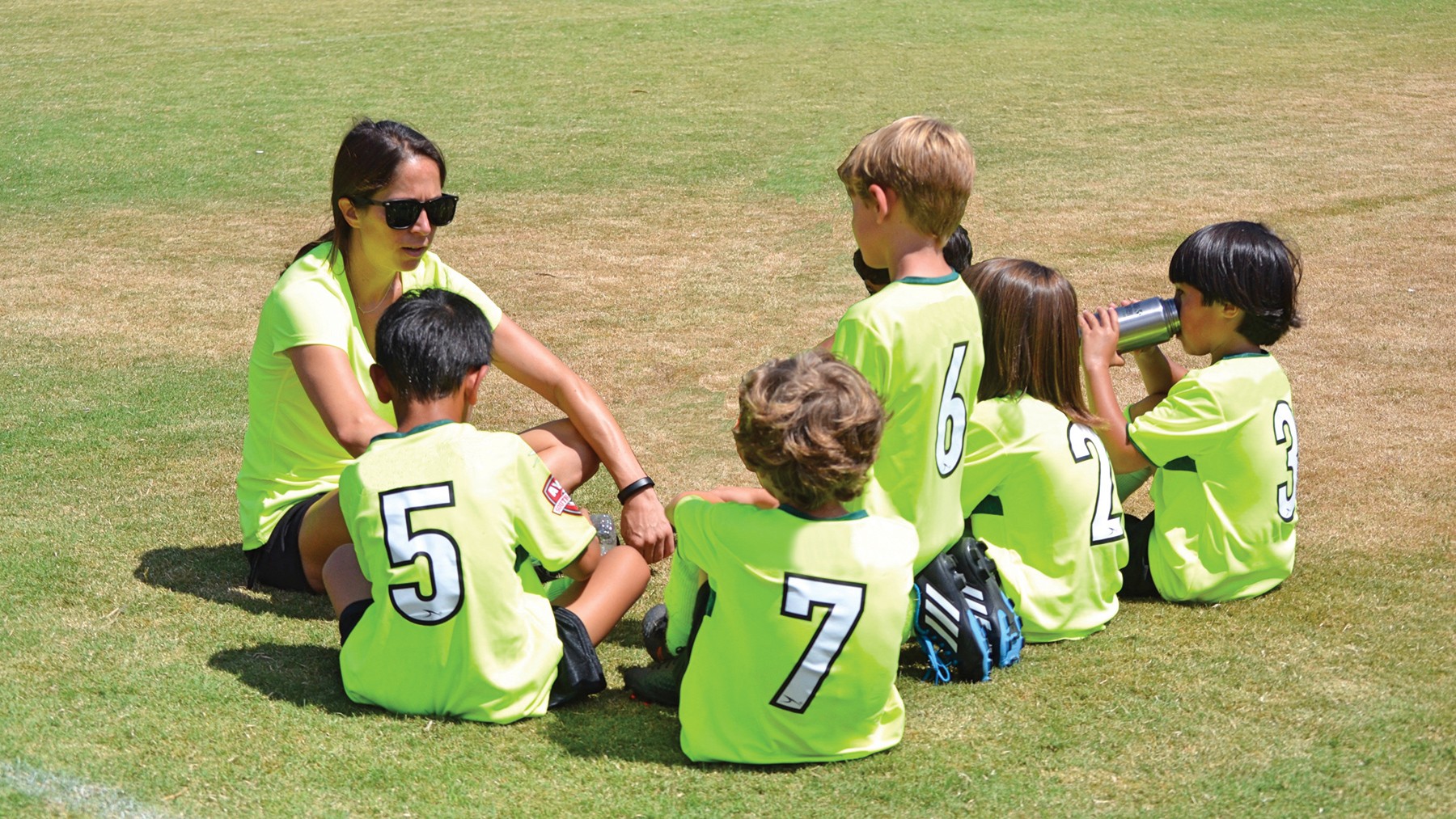 a group of children sitting on steps in front of a building