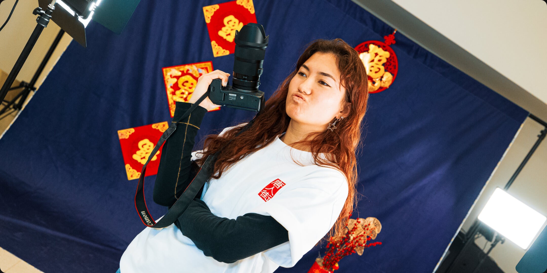 A display features Lunar hard seltzers alongside jars of Bowlcut Spicy Chili Crisp and Fly By Jing Zhong Sauce. The seltzer boxes, showcasing flavors like lychee, yuzu, passion fruit, and Korean plum, emphasize their use of real fruits from Asia.