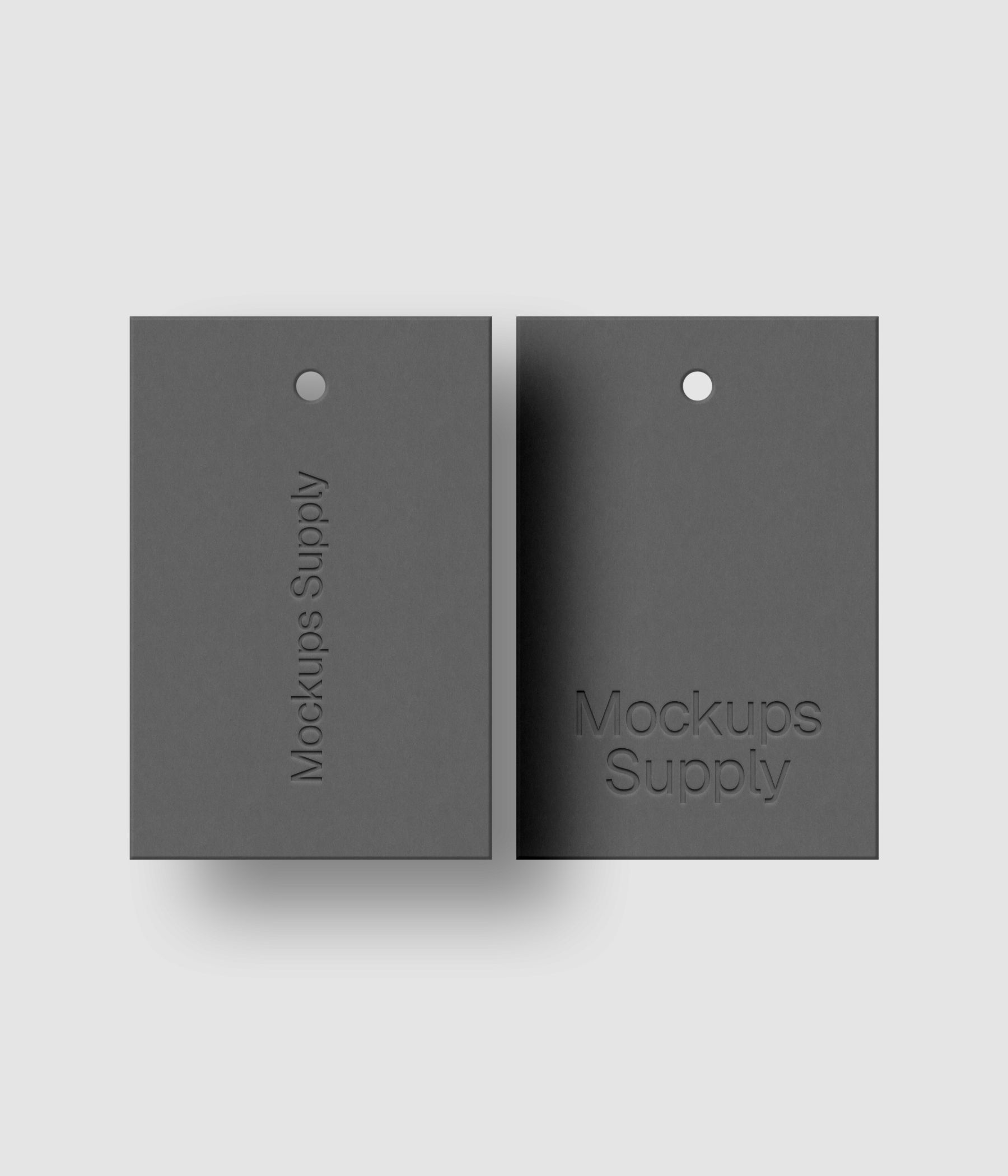 Two gray 2x3 hang tags mockup on white background with debossed logo effect and natural shadow depth for Photoshop download psd