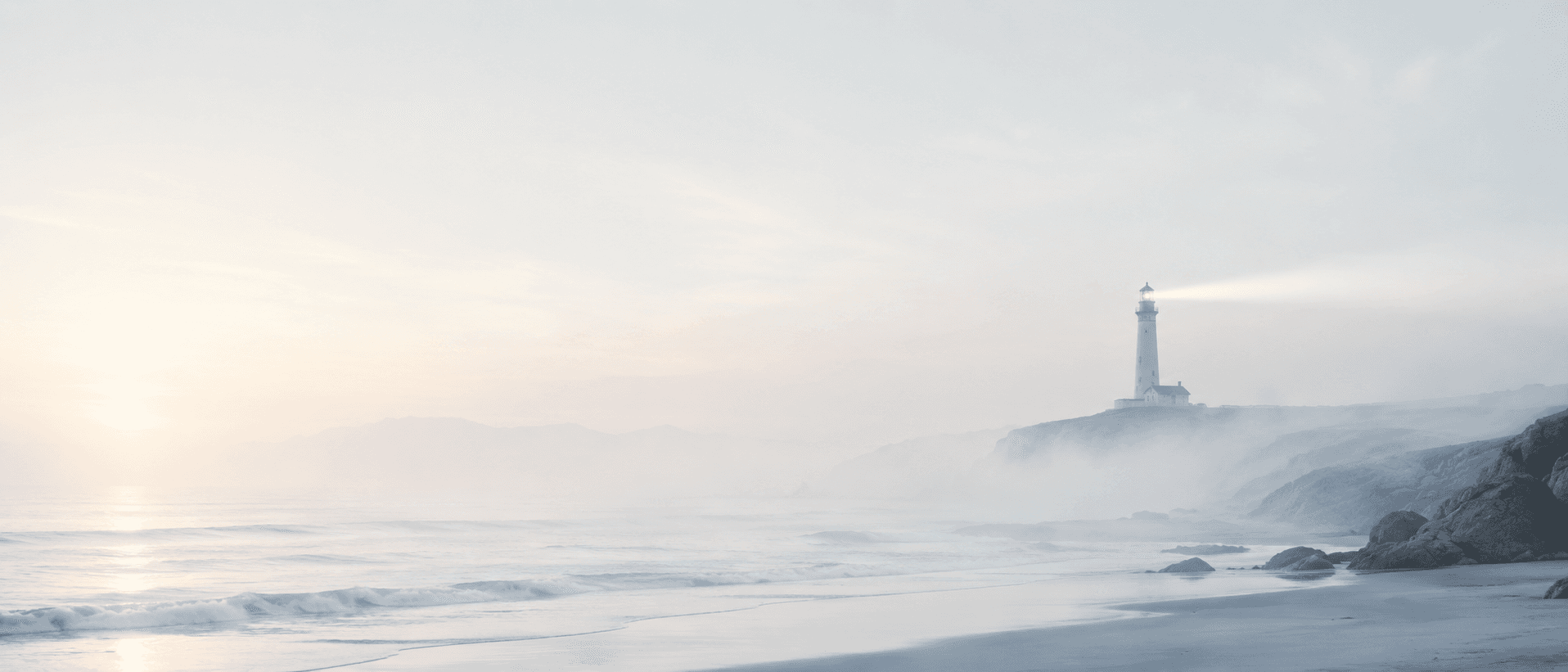 A pale misty coastal scene at dawn with a faint lighthouse beam, representing the gradual fading of online visibility when a small business website goes unmaintained.