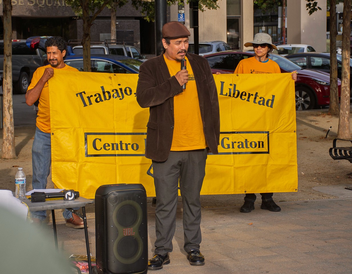 People standing next to a sign