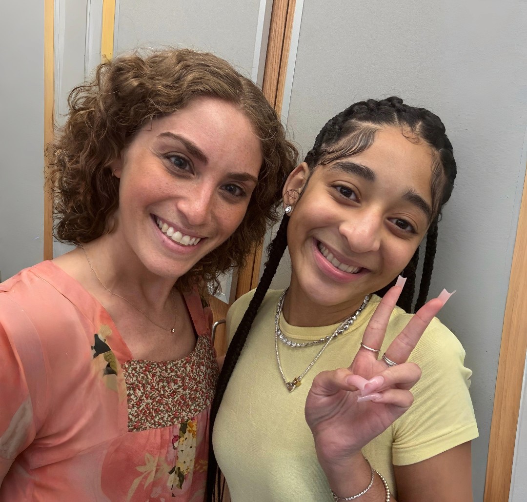 Photo of selfie of mentor with student posing for camera.