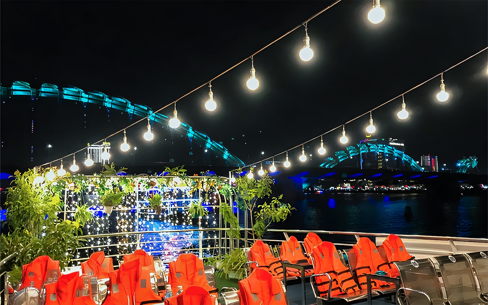 My Xuan Cruise deck on Han River at night with city lights and bridge in view.