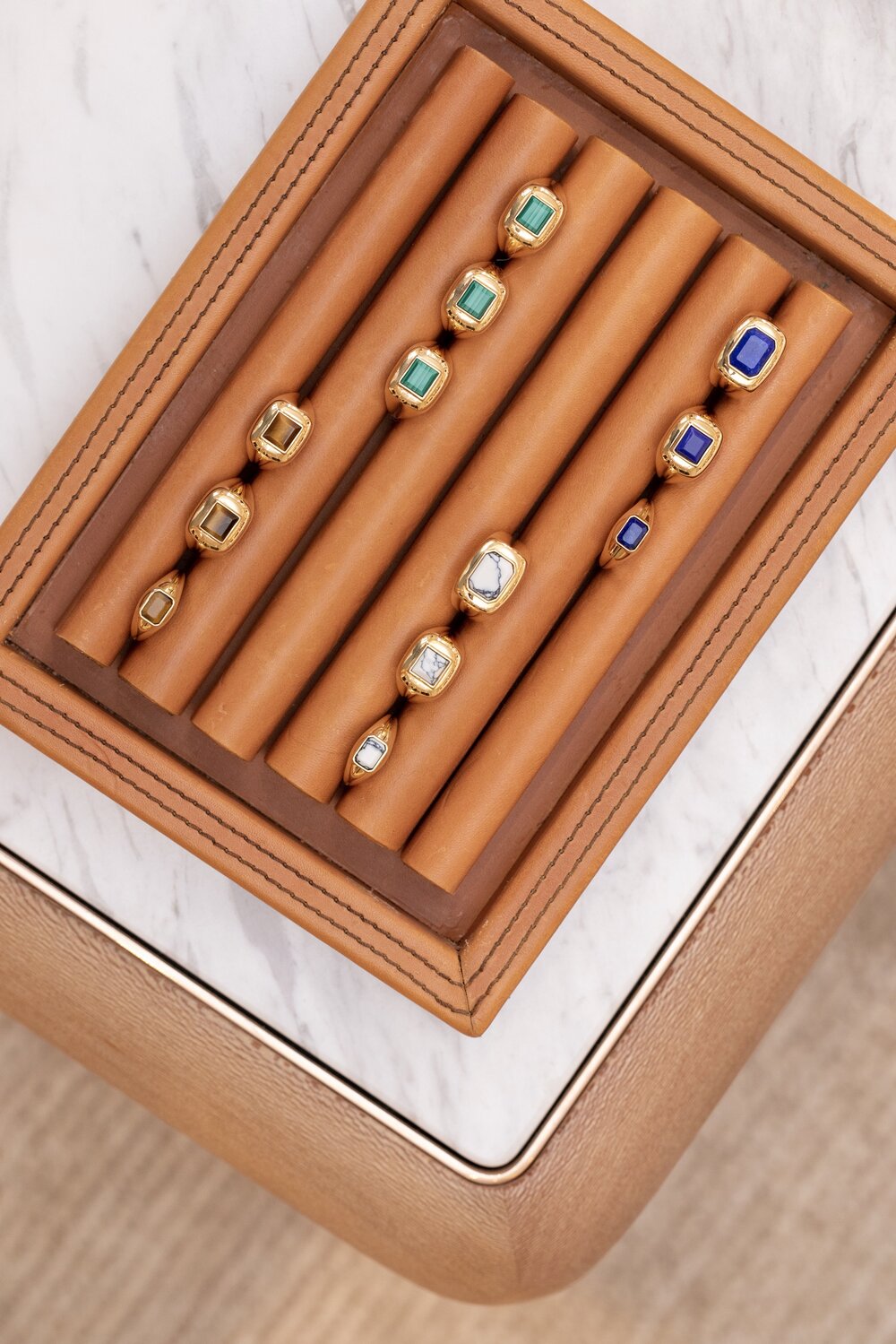 A close-up of a wooden board with colorful rings neatly arranged in rows.