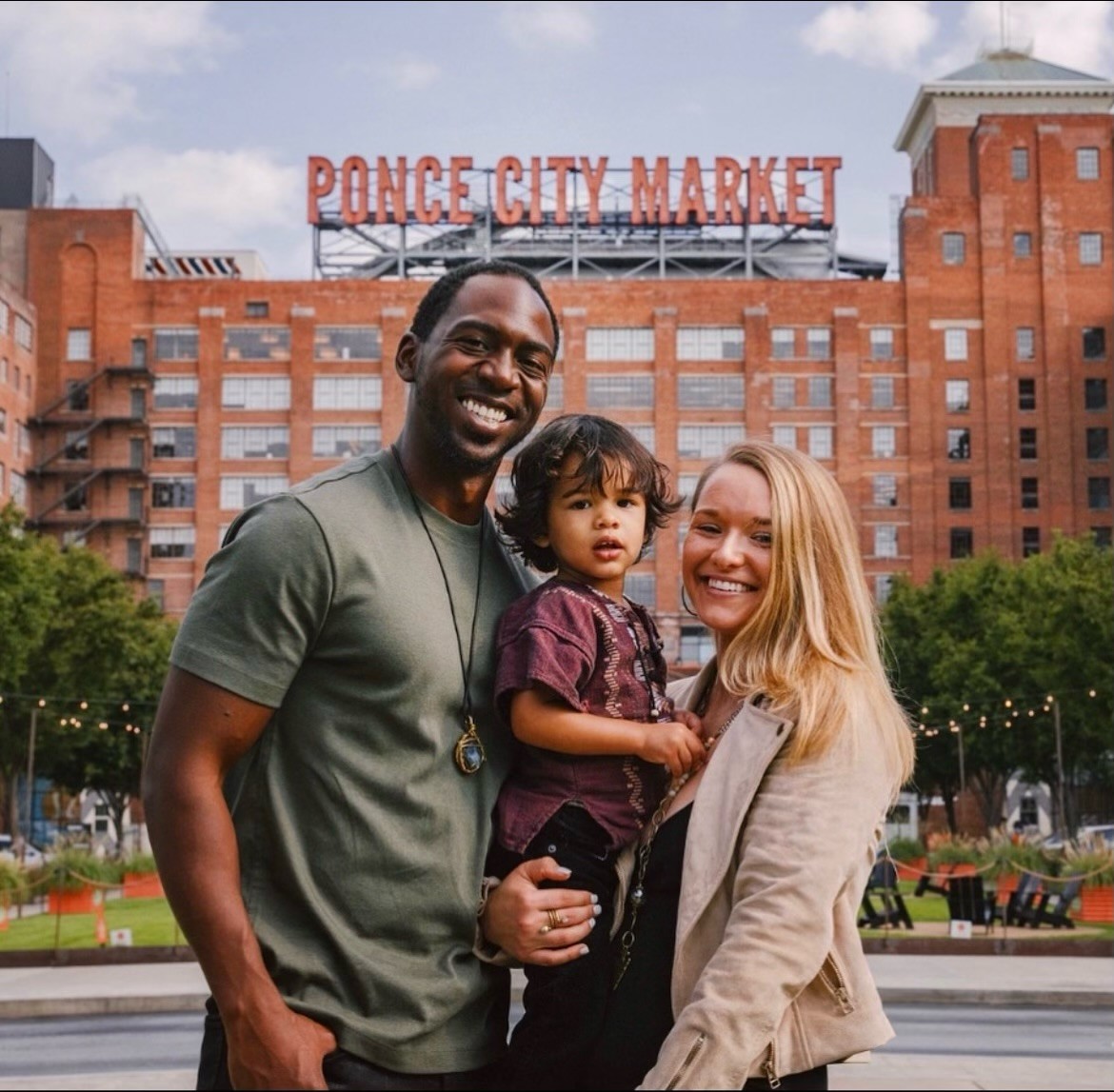 Happy family photo standing in front of Ponce City Market