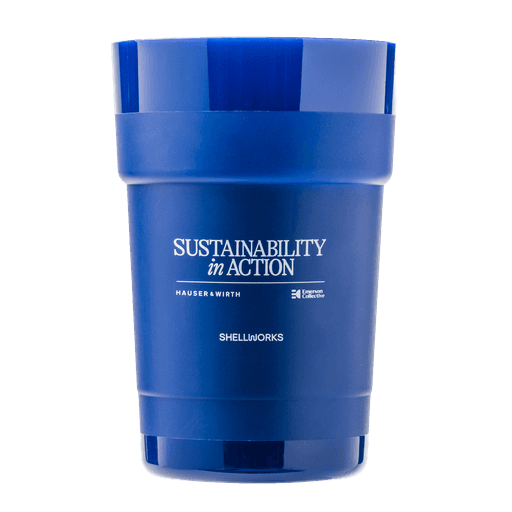 A vibrant blue, plastic-free reusable cup reading "Sustainability in Action." Manufactured by Shellworks, it exemplifies VIVOMER's core promise: delivering the performance and function of conventional plastic with none of the legacy pollution.