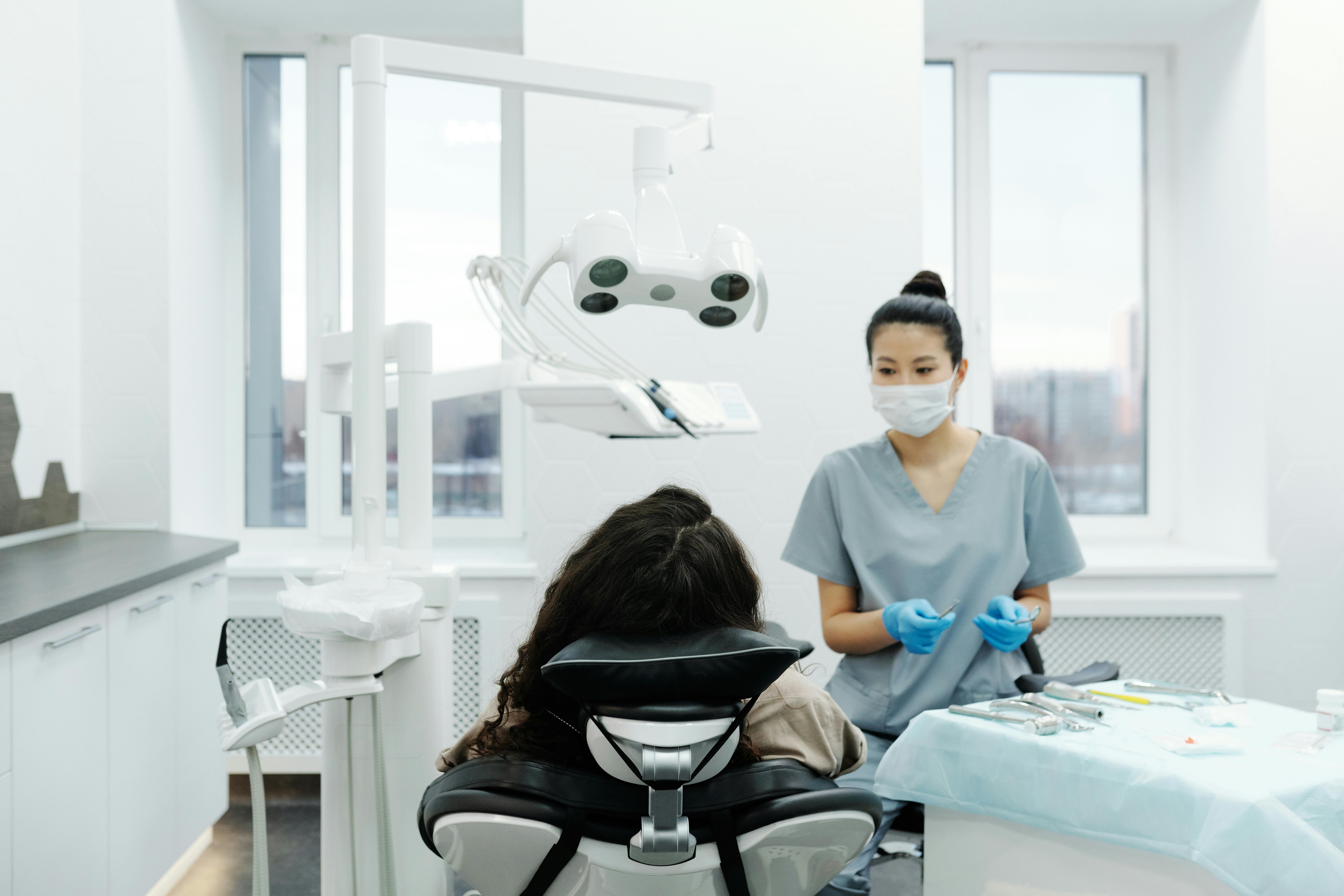 Dental hygienist working with patient 