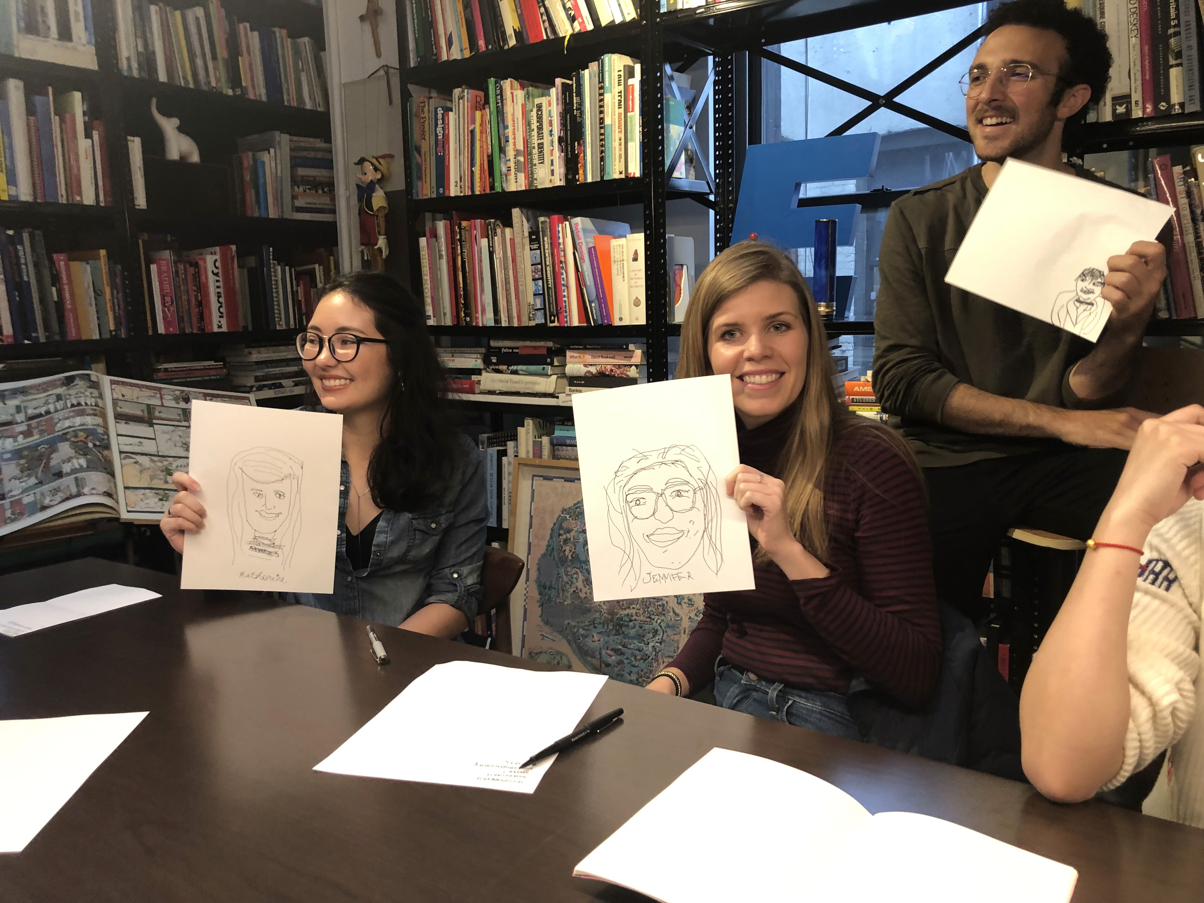 students drawing faces on papers