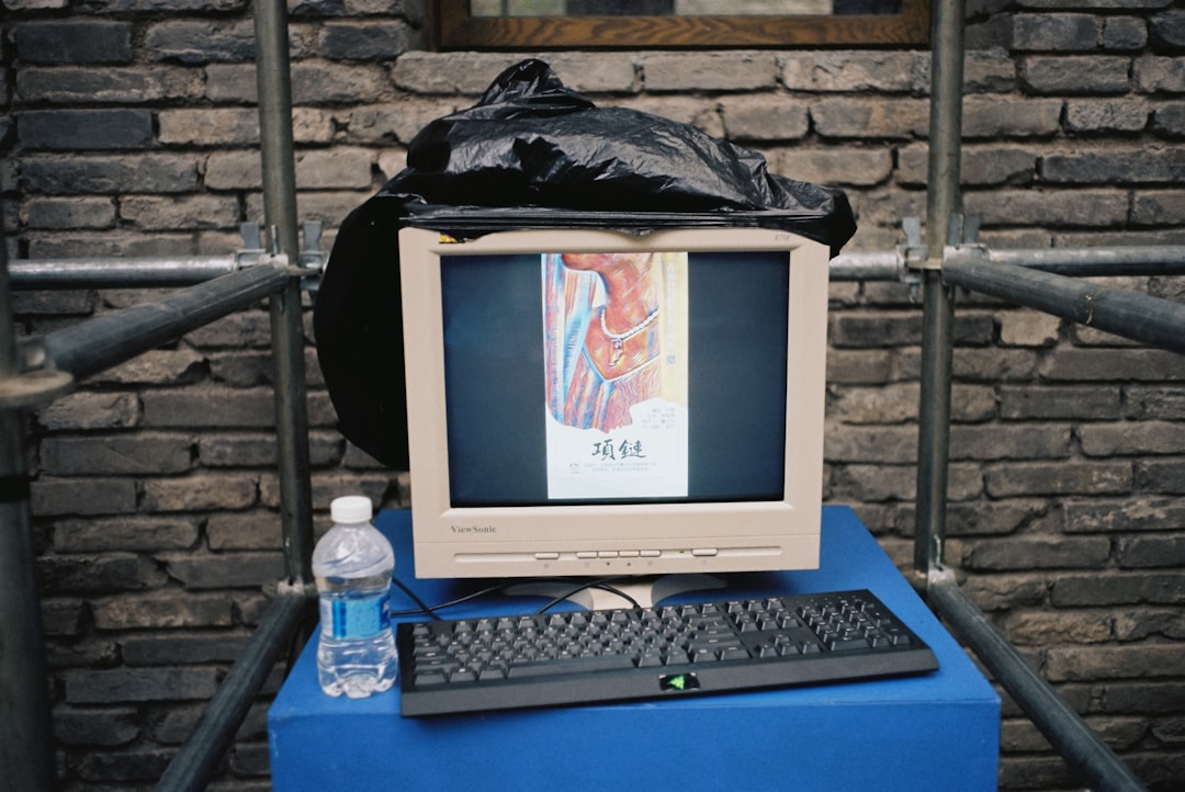 white crt computer monitor on blue table