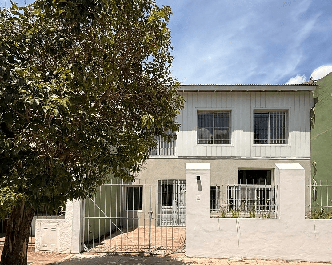 white and brown concrete building near green grass field during daytime