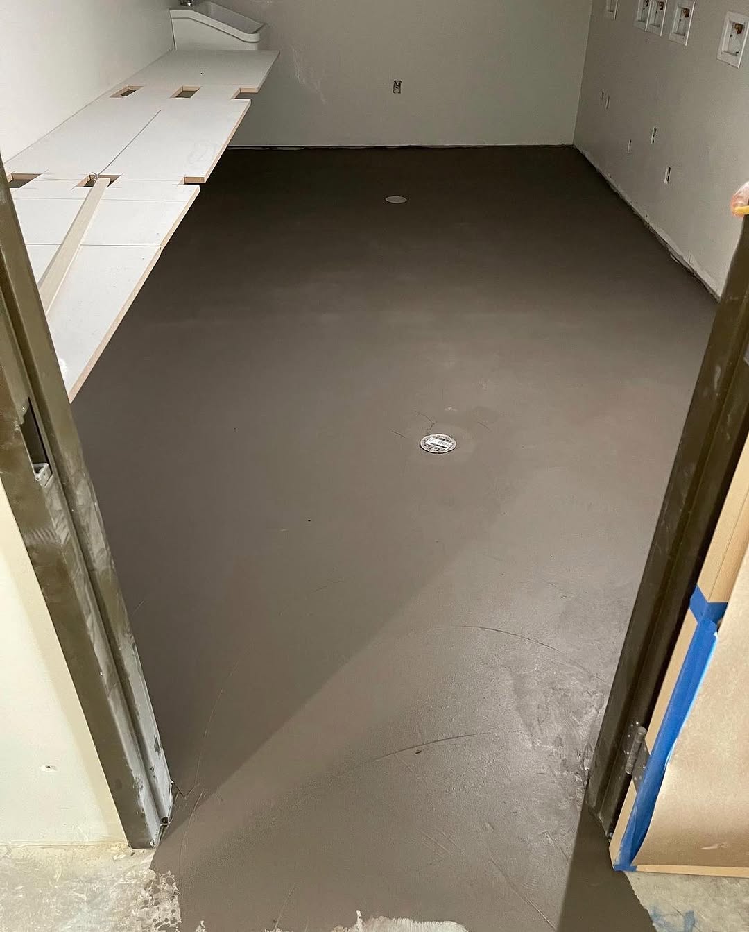 Finished grey sheet vinyl floor in a completed room