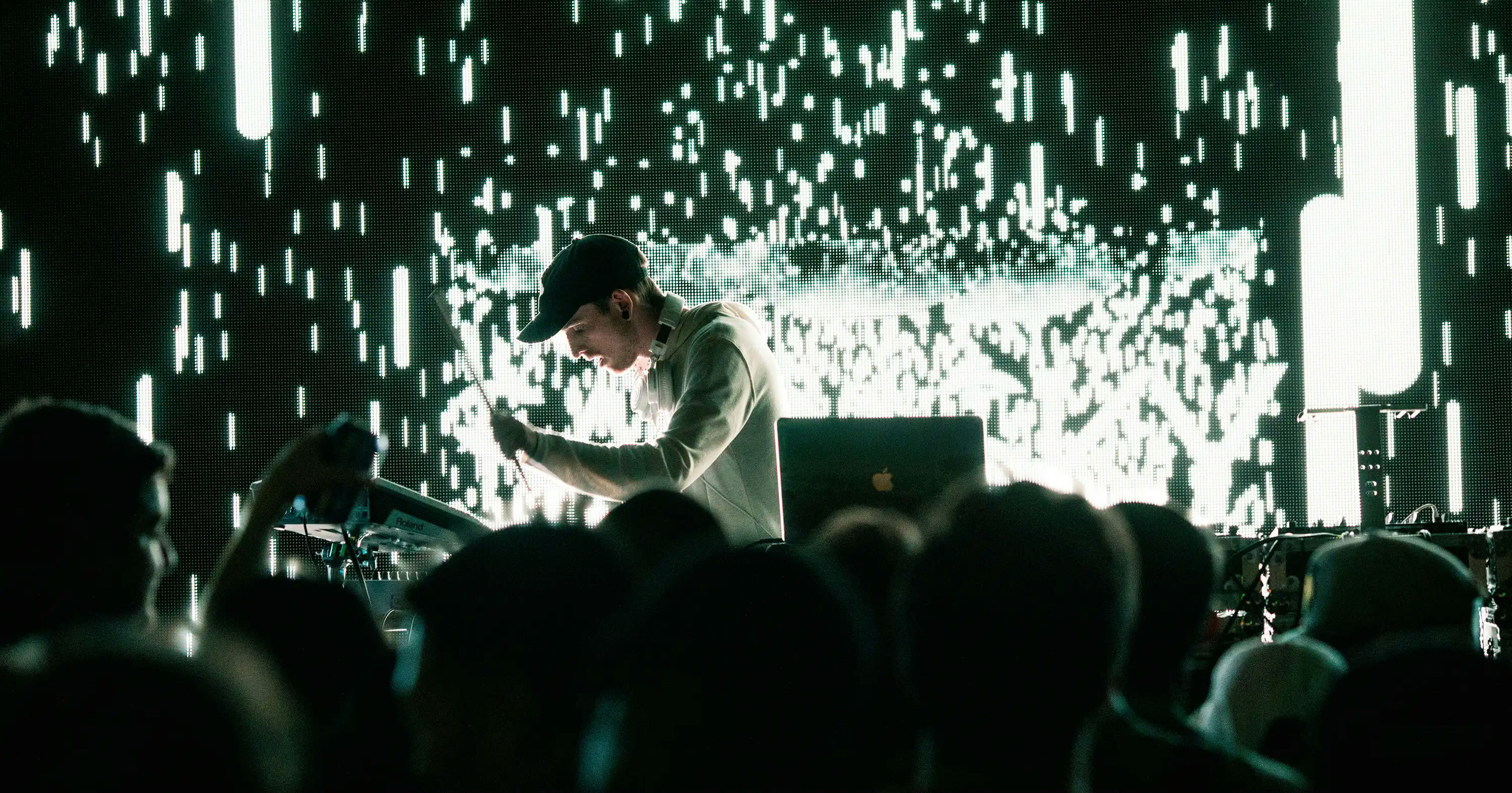 A dj in a live show with sparks flying in the background