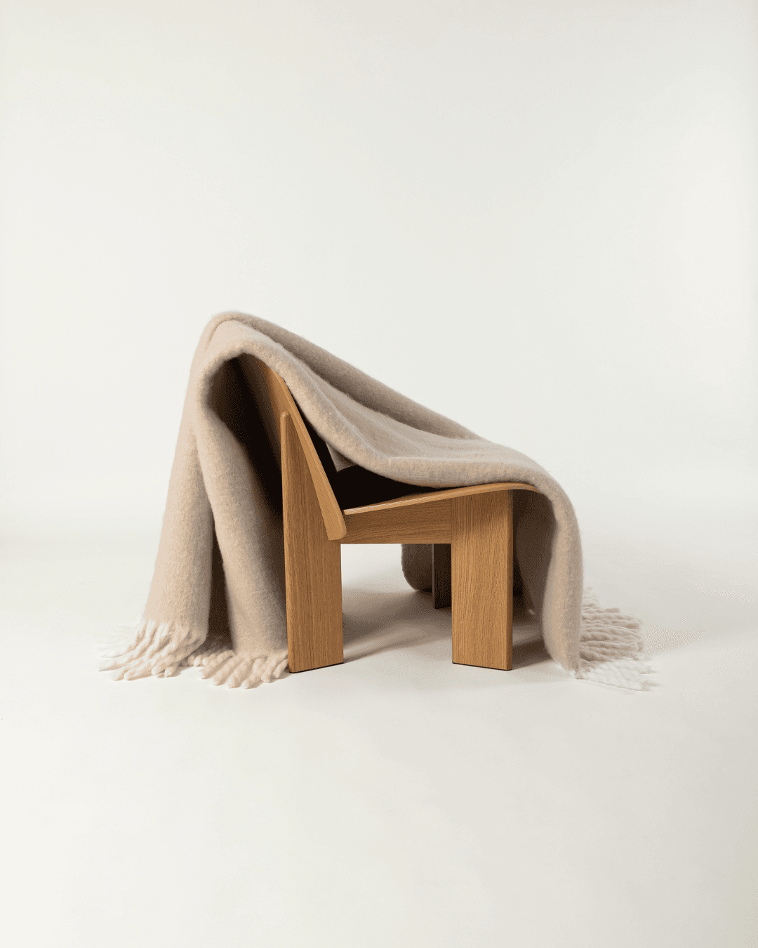 Faux Mohair Blanket in Clay/Moon draped over wooden chair