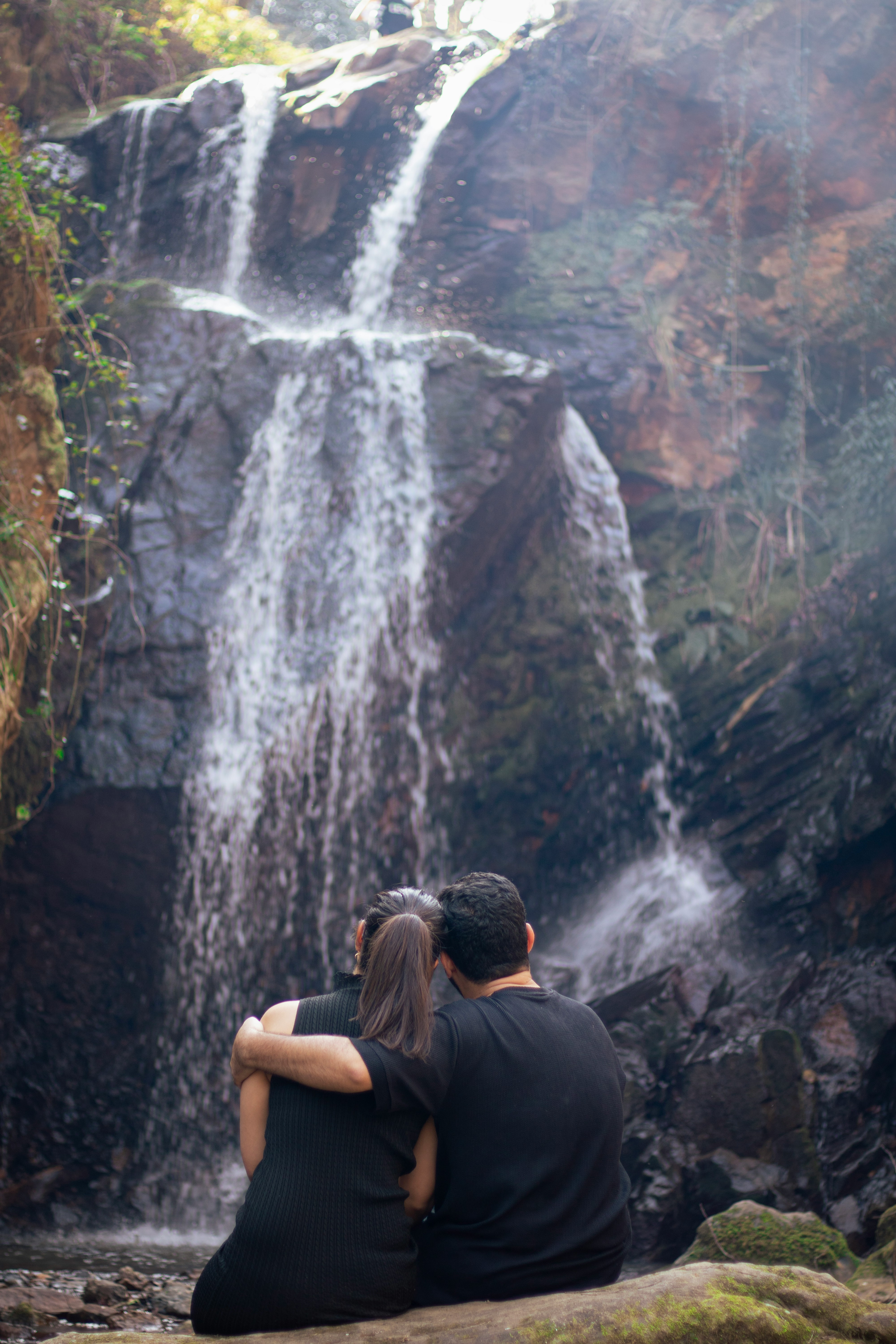 couple in front of a waterfall