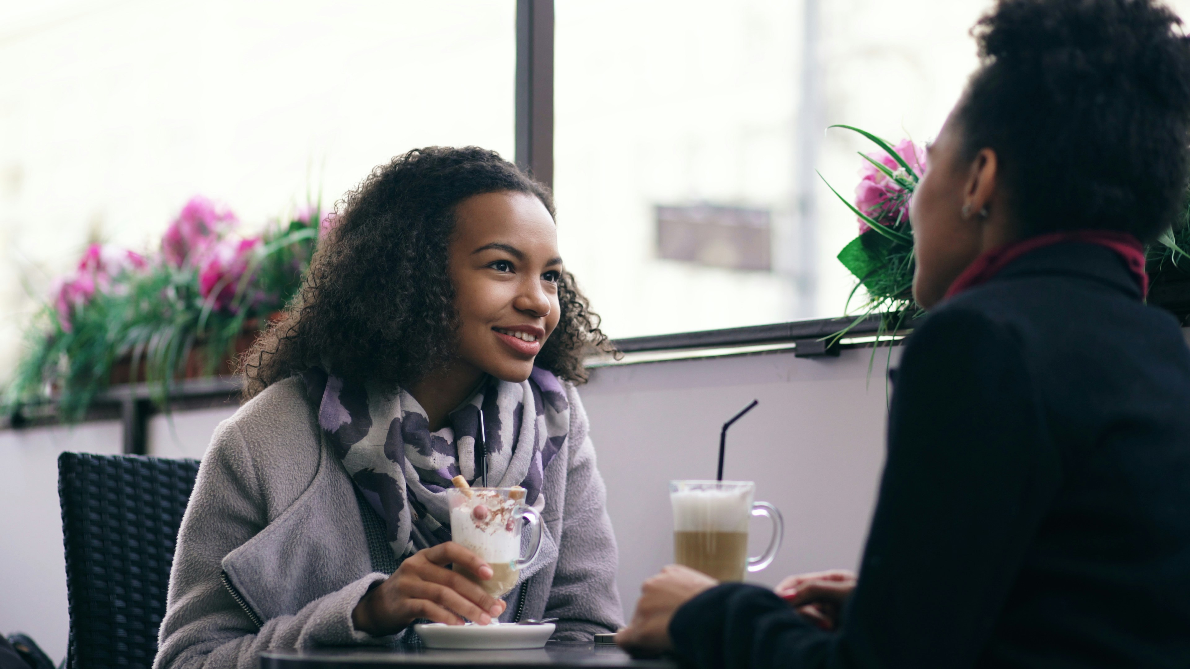 Two young professionals chatting over coffee