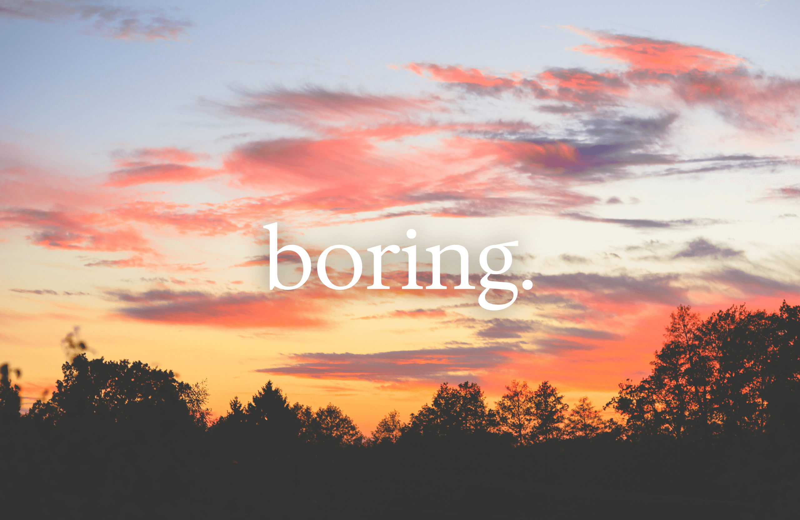 A sunset with a dark treeline with the word "boring" in white overlayed. 