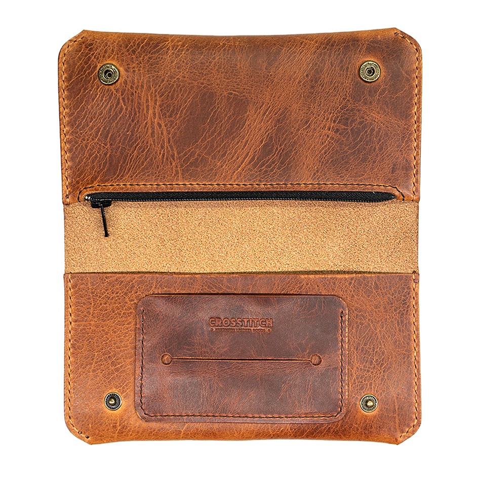 Crosstitch Leather craftsman hand-stitching a wallet in workshop