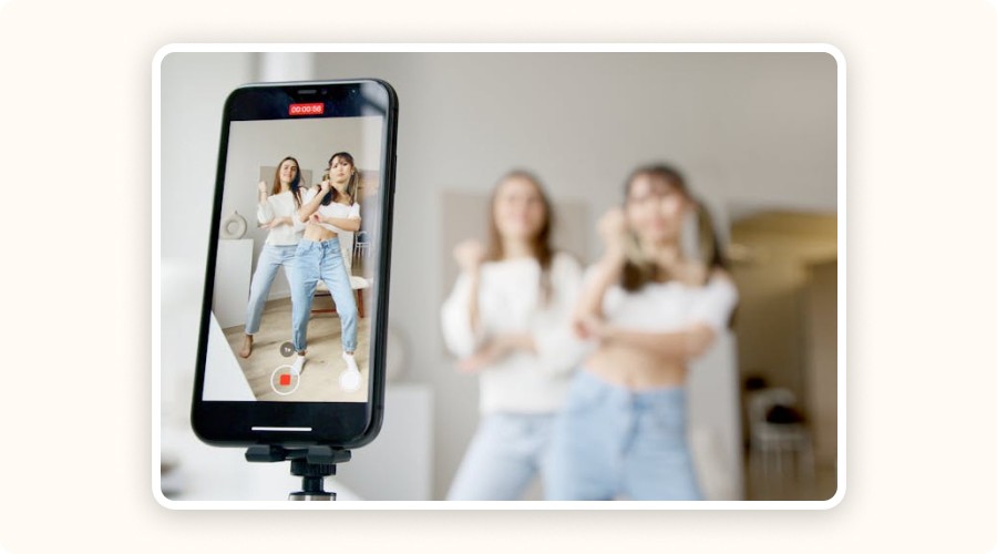 Two young women filming a social media dance video — example of influencer content.