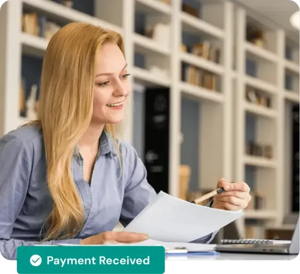 Business professional reviewing invoices and accounts receivable using payment automation software.