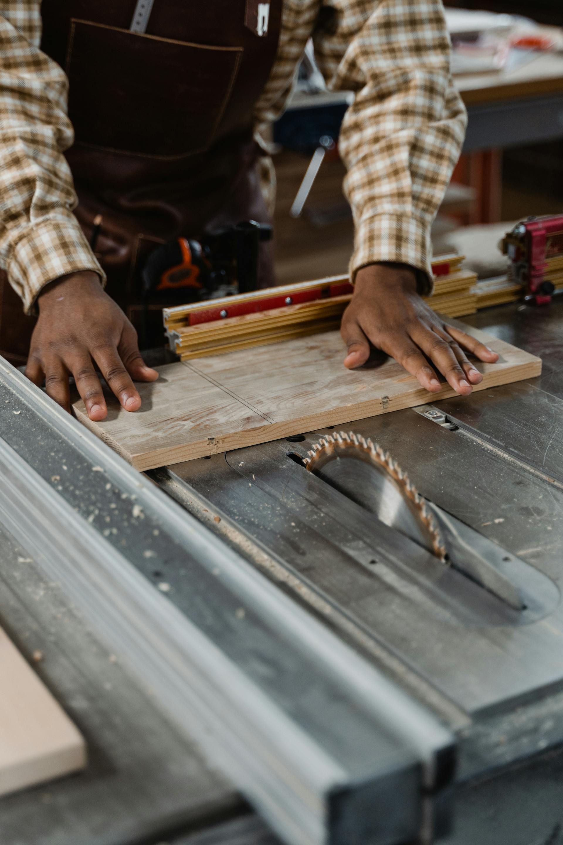 Cutting wood boards on table saw for custom deck construction in Ottawa