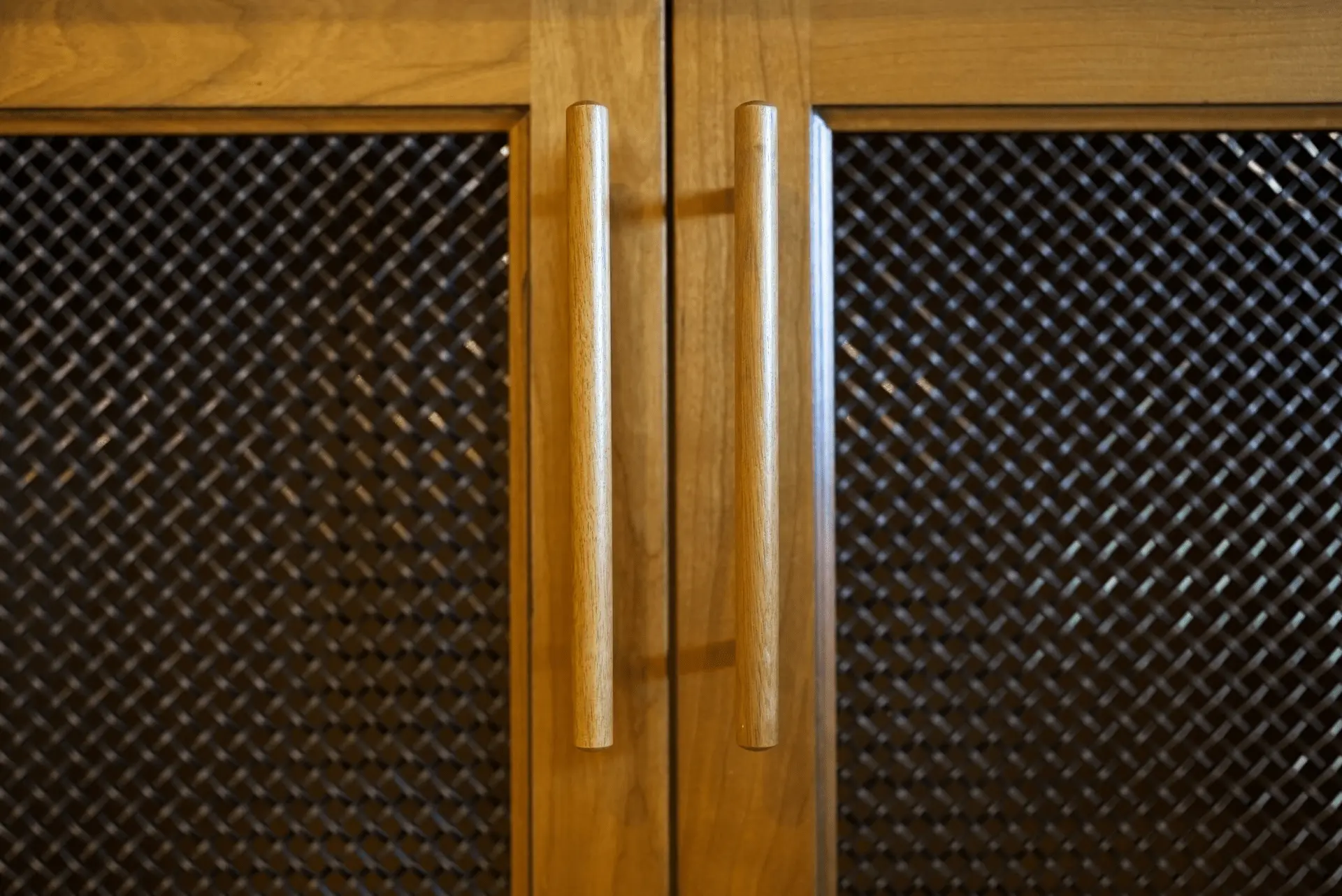Close-up of the entertainment room's cabinetry door handles, showcasing the elegant hardware choices in the San Juan Capistrano remodel. Photo by Todd Huge.