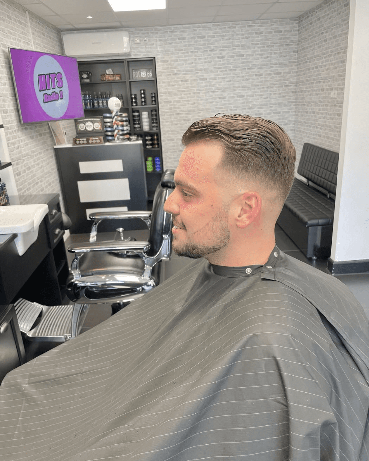 Barber posing with razor and scissor