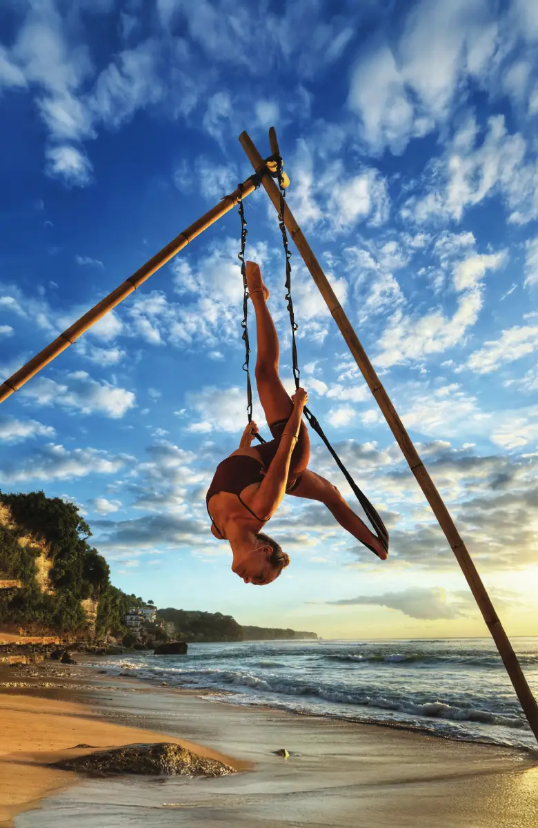 Outdoor aerial yoga flow on bamboo tripod rig by Ulu Yoga Bali instructors