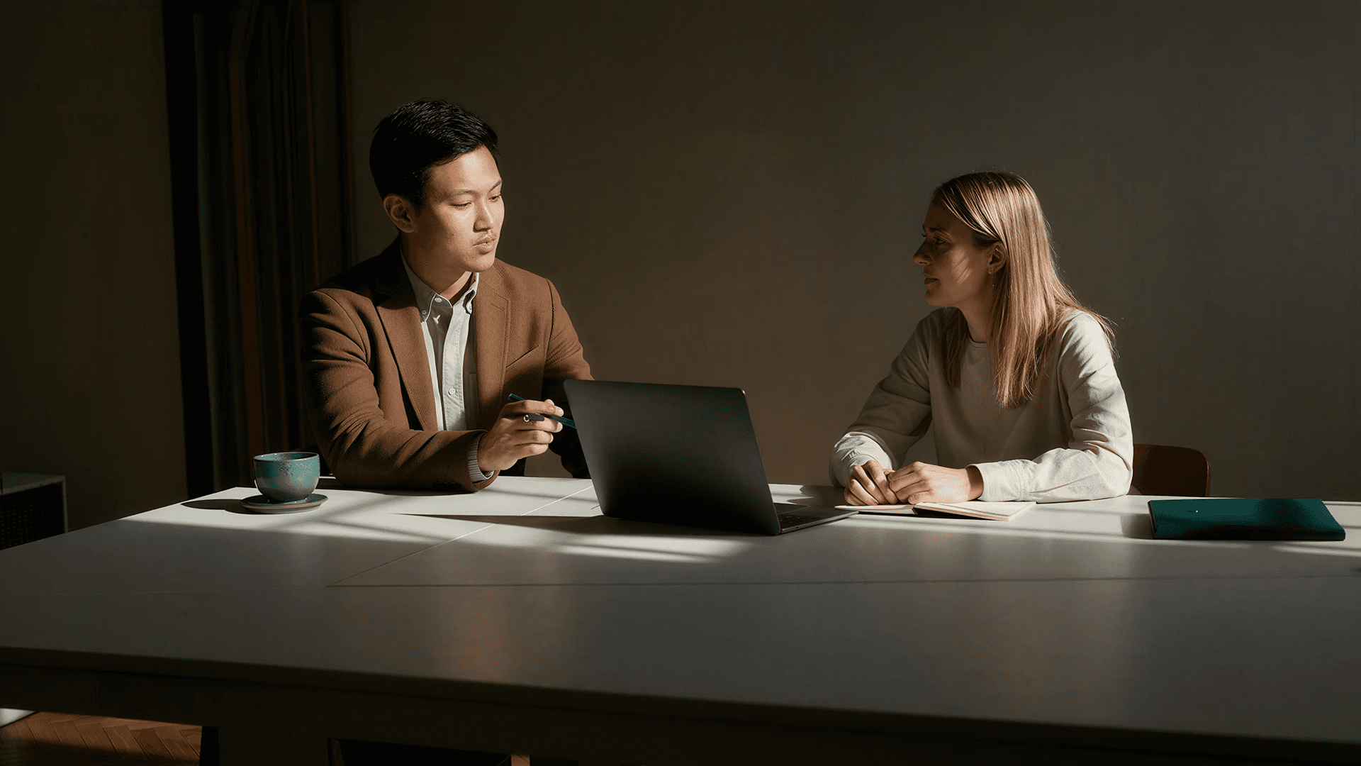 Wealth adviser reviewing information on a laptop with a client