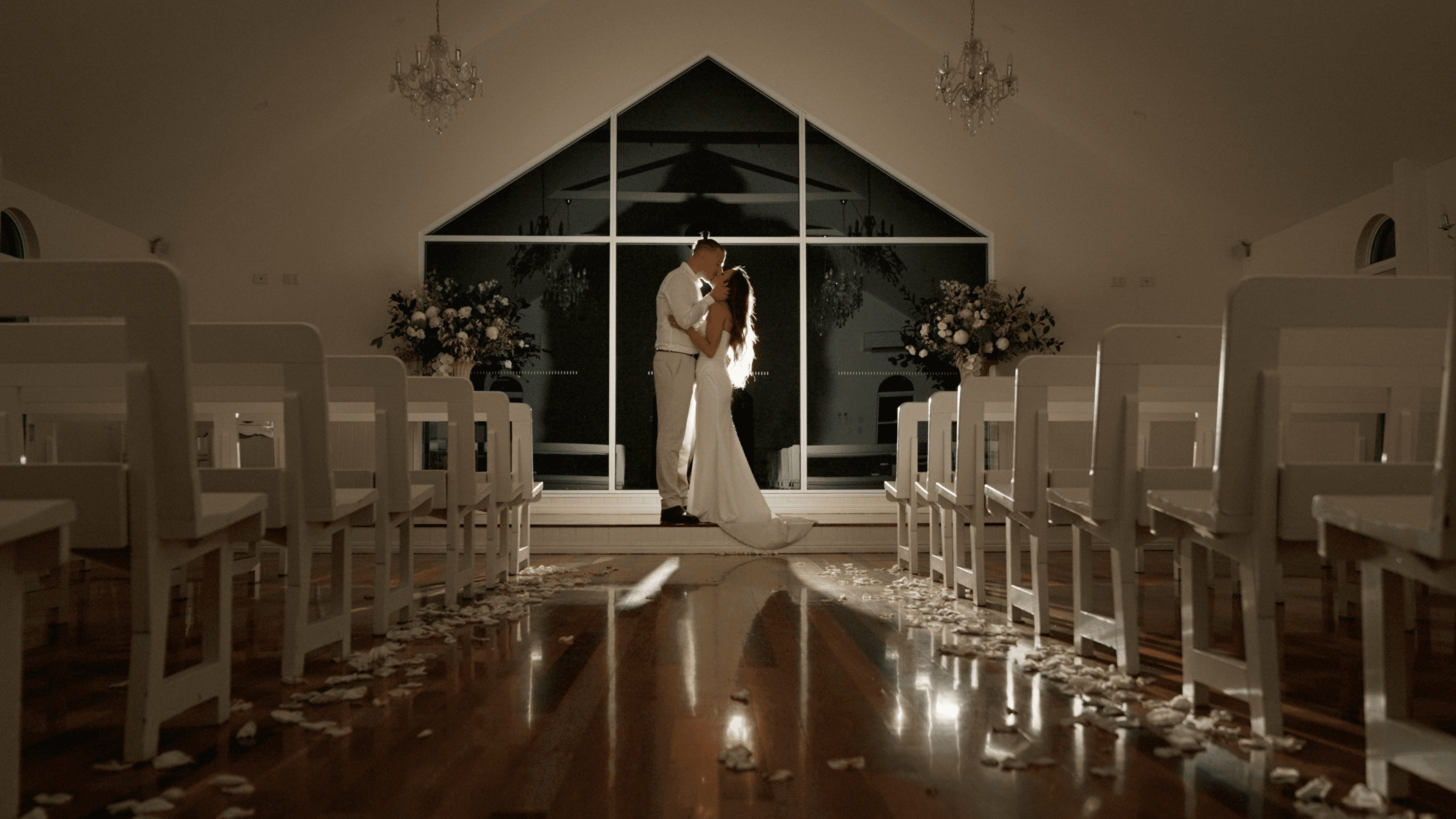 Olivia & Wayne sharing a beautiful quiet moment in the chapel at Tiffany's Maleny, shot by Creo Bella Luxury Wedding Films, Brisbane Wedding Filmmaker