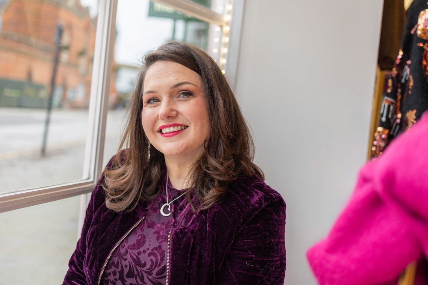Lucy sitting next to the window in Feather and Sole