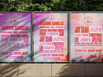 man wearing grey t-shirt standing in front of man sitting on chair