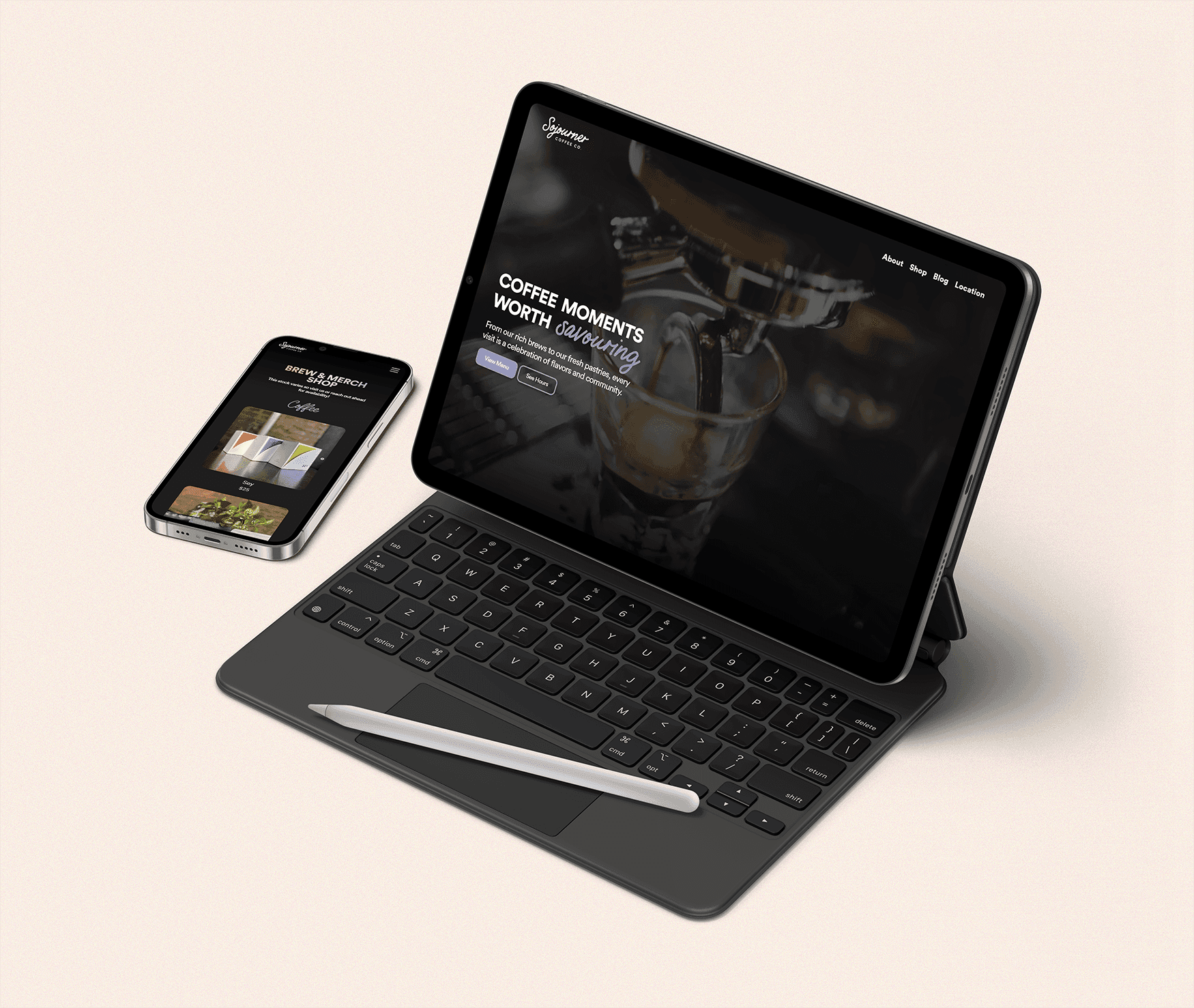 Landscape IPad with keyboard attachment and Apple pen and IPhone on on a light surface displaying website mockups