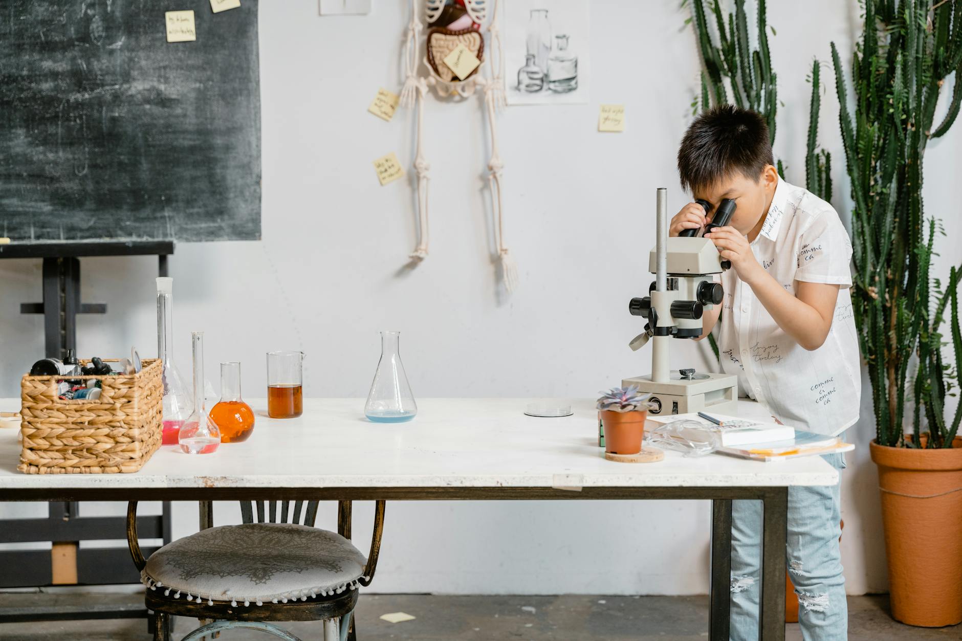 A high school science teacher wearing safety goggles while demonstrating a chemistry experiment for a class.