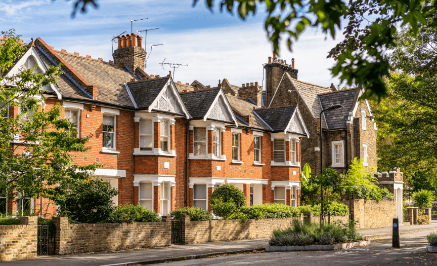Modern bathroom featuring wooden cabinetry, a bathtub, a sleek sink, and natural light from a window.